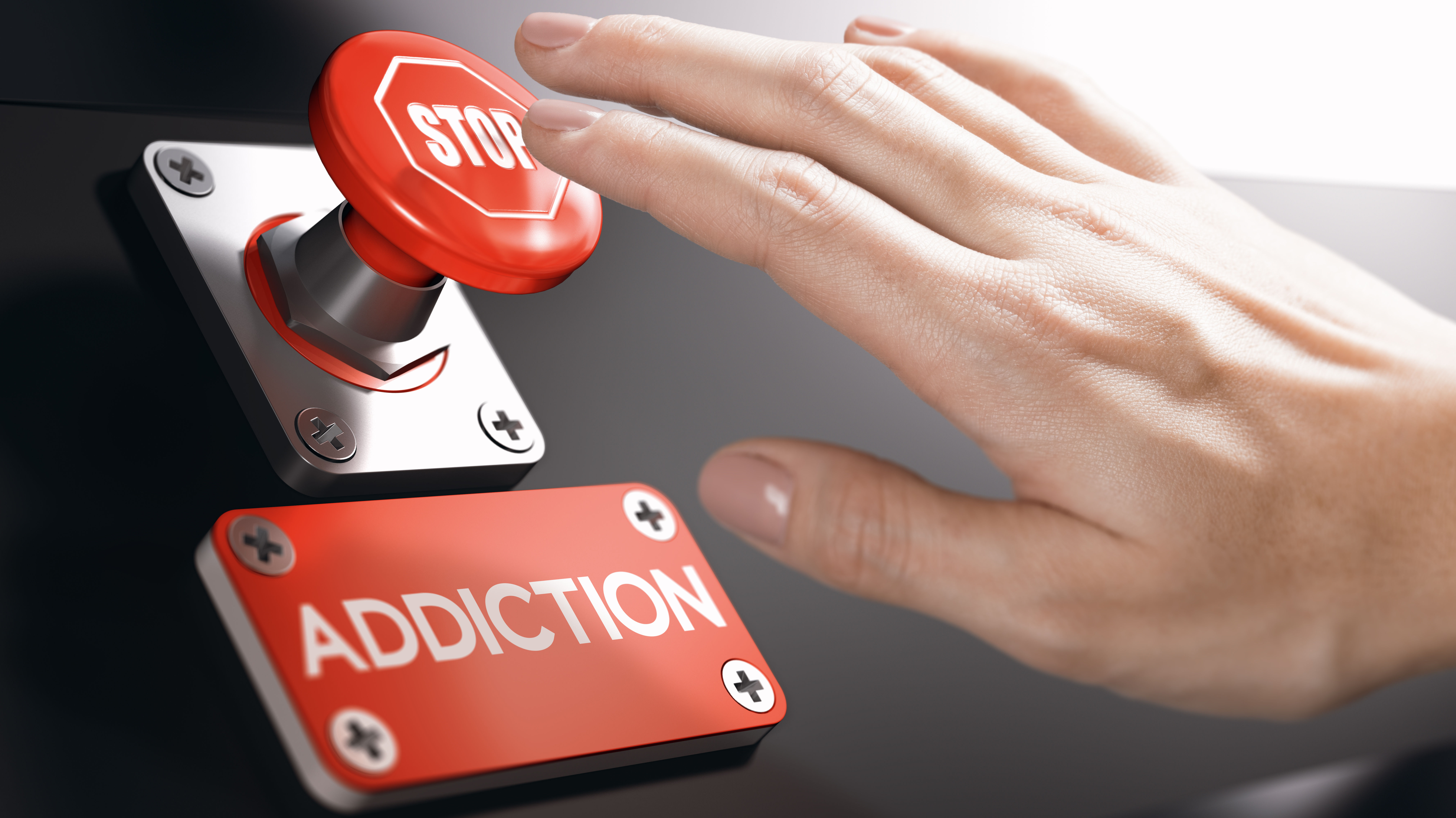 Hand die einen Button Stop drückt und untendrunter steht Addiction. Hand die einen Button Stop drückt und untendrunter steht Addiction.